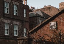 An old urban scene showcasing brick buildings with a vintage charm and architectural details.