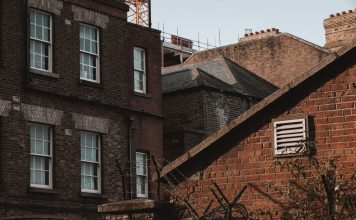 An old urban scene showcasing brick buildings with a vintage charm and architectural details.