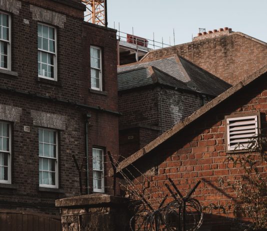 An old urban scene showcasing brick buildings with a vintage charm and architectural details.