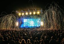 Dynamic live music concert with vibrant stage lights and a lively crowd enjoying the night.