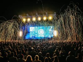 Dynamic live music concert with vibrant stage lights and a lively crowd enjoying the night.