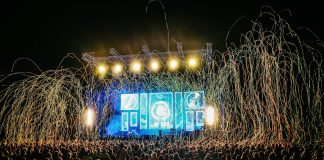 Dynamic live music concert with vibrant stage lights and a lively crowd enjoying the night.