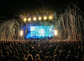 Dynamic live music concert with vibrant stage lights and a lively crowd enjoying the night.