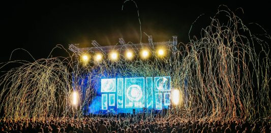 Dynamic live music concert with vibrant stage lights and a lively crowd enjoying the night.