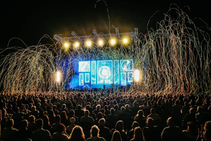 river-city-fair-returns-to-hoboken-waterfront-with Dynamic live music concert with vibrant stage lights and a lively crowd enjoying the night.