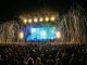 Dynamic live music concert with vibrant stage lights and a lively crowd enjoying the night.