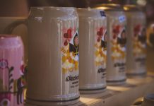 Close-up of colorful beer steins at Oktoberfest in Munich, Bavaria, highlighting festive designs.