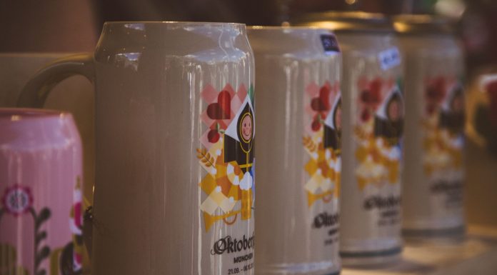 Close-up of colorful beer steins at Oktoberfest in Munich, Bavaria, highlighting festive designs.